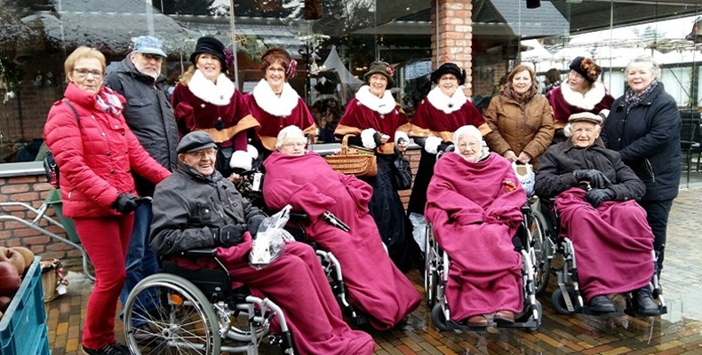 Deelnemers en vrijwilligers genieten op de Winterfair in Garderen van het kerstkoor, van de kraampjes met leuke spullen en de kerstfeer